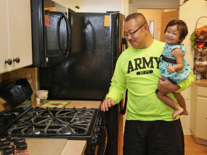 Vu Brown marvels at his new appliances with his granddaughter. 