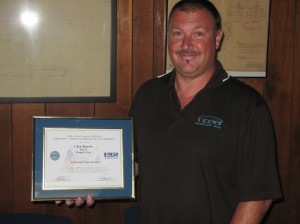 Chris Durost with the recognition from the Department of Defense for Justin Hartley and Peoples Gas.